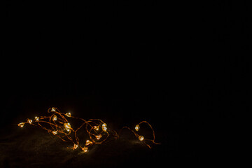 garland on a black background glows yellow