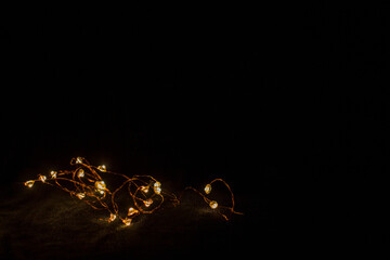 garland on a black background glows yellow