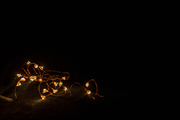 garland on a black background glows yellow