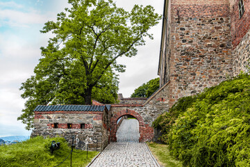 July 27, 2013 Oslo, Norway Akershus fortress. Stone arch over the road of paving stones