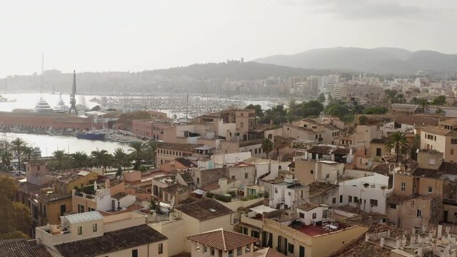 Old town in Palma on the island of Mallorca Spain dron 4K video. Aerial view of historic streets with houses, Mediterranean seafront church with beautiful urban landscape.