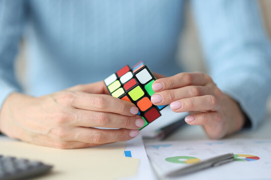 Female hands holding Rubik Cube closeup
