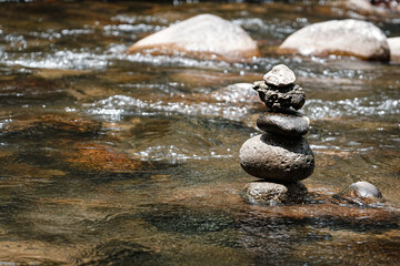 Fototapeta premium Stacks of pebbles in the river