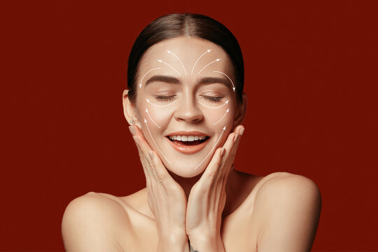 Beautiful female face with lifting up arrows isolated on red background. Concept of bodycare, cosmetics, skincare, correction surgery, beauty and perfect skin. Flyer for your ad. Antiaging.