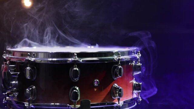 Close up of snare drum with smoke in the dark with beautiful lighting close up.