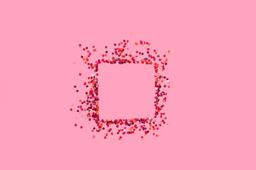 Colored confetti square shape on pink background