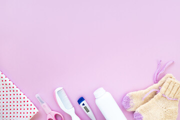 Baby care kit on pink background, top view, copyspace. Concept of children's hygiene. Flat composition with children's accessories, background.