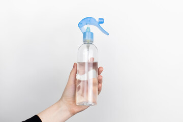 A woman is holding an air freshener. Place for your text. The concept of hazardous substances in cosmetics and household chemicals