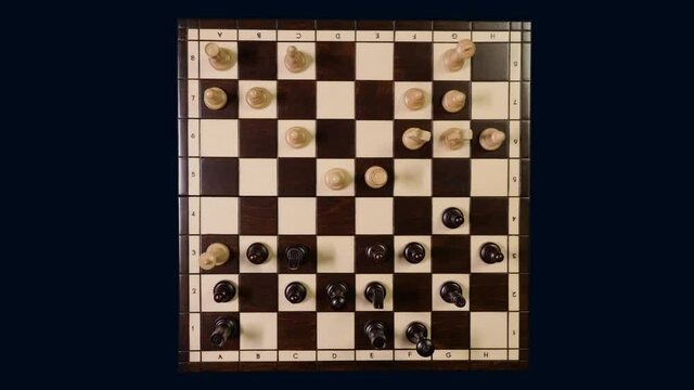 Timelapse top view chess game. Wooden chessboard on a dark background with chess pieces