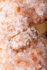 Pink Himalayan salt. Himalayan salt pile. Pink crystal salt in wooden spoon. Food background. Close...