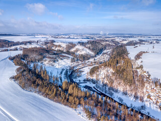Aerial view of river valley landscape , winter theme. Czech Republic, Vysocina region highland. In background city Jihlava with smoking factory.