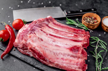 raw pork ribs on a stone background