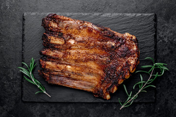 grilled pork ribs on a stone background	