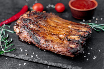 grilled pork ribs on a stone background	