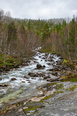 Flat waterfall with many stones in Norway