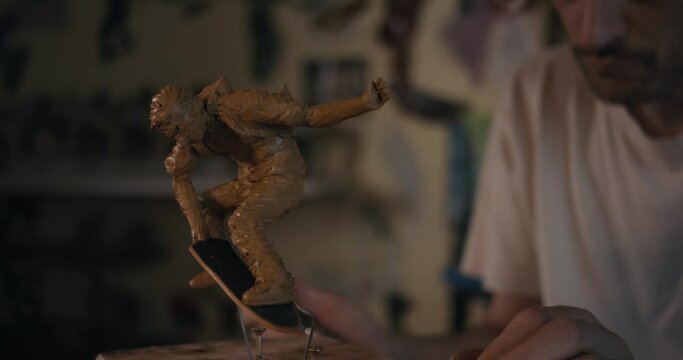 Artist Look At Clay Miniature Skateboarder Sculpture Model Close Up