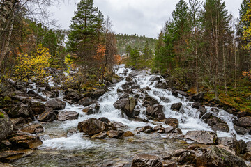 Flat waterfall with many stones in Norway