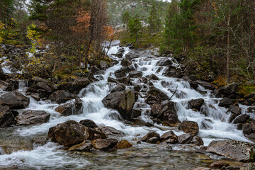 Flat waterfall with many stones in Norway