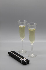 two vintage crystal glasses of champagne and black present box 