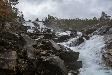 Flat waterfall with many stones in Norway
