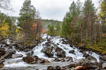 Flat waterfall with many stones in Norway