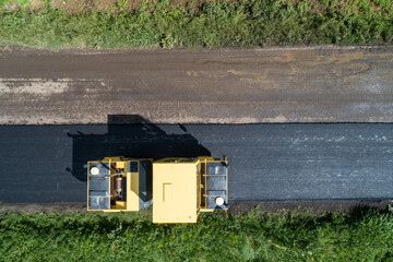 Road roller machine rolls asphalt