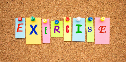 Color notes with letters pinned on a board. Word EXERCISE.