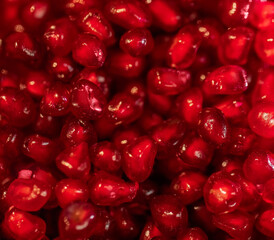 Red pomegranate seeds on a white background. Close-up. Fruit, food. Photophone, wallpaper, texture, texture. Copy space.