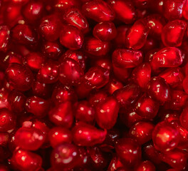 Red pomegranate seeds on a white background. Close-up. Fruit, food. Photophone, wallpaper, texture, texture. Copy space.
