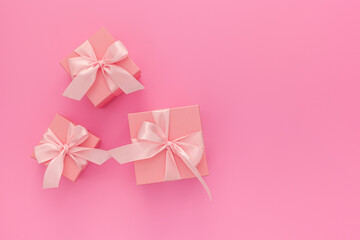 Valentines day composition: three pink gift boxes with ribbon
