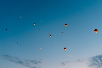releasing flying lanterns at dusk