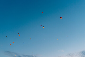 releasing flying lanterns at dusk