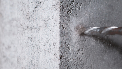 Detail of drill making hole into concere wall