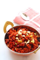 Gajar Halwa. Indian carrot pudding. It's a sweet dessert made from carrots, sugar, and cream. Garnished with cashew, almond, Raisin, and pistachio.