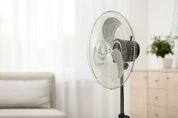 Modern electric fan in room. Space for text - obrazy, fototapety, plakaty