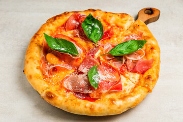 Pizza with pumpkin, prosciutto and basil