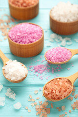Different types of salt on blue background.