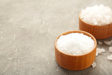 Sea salt in bowl on grey background