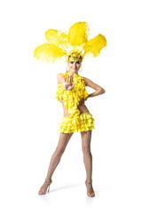 Fit beauty. Beautiful young woman in carnival, stylish masquerade costume with feathers dancing on white studio background. Concept of holidays celebration, festive time, dance, party, having fun.