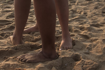 Fototapeta na wymiar legs on the beach