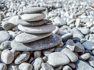 Nice abstract background pattern with large gray pebble sea stones. Pyramid of stones