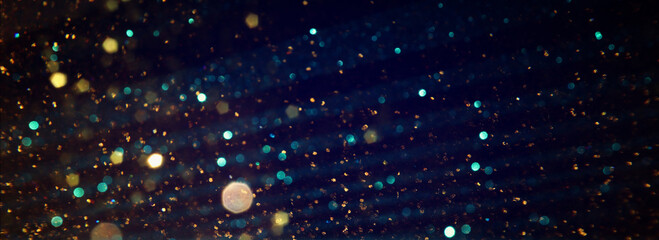 Fototapeta na wymiar background of abstract gold and black glitter lights. defocused