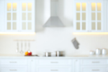Blurred view of modern kitchen interior with white furniture