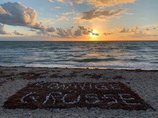 Sunny greetings from Flügger beach with beautiful sunset, clouds and waves near Jimi Henrix memorial on Fehmarn