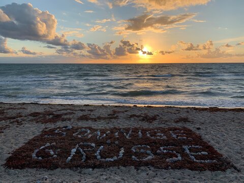 Sunny greetings from Fl&uuml;gger beach with beautiful sunset, clouds and waves near Jimi Henrix memorial on Fehmarn
