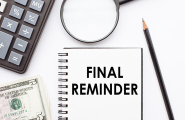 Notepad with FINAL REMINDER note on desk with calculator, dollars and magnifier.