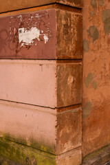 Rust corner of the building. Orange shabby grunge wall. Shabby background.