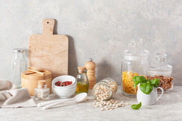 kitchen utensils on modern simple counter, kitchenware jars with dry ingredients bowls