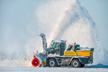Snow removal vehicle in the airport. Snow blower. Cleaning airport from snow. Cleaning runway from...