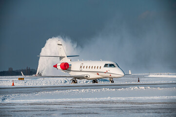 White luxury business jet on the winter airport apron.